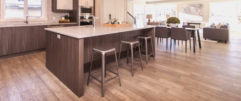 A kitchen with big island and chairs