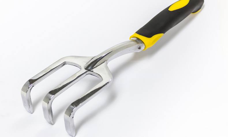 Metal hand cultivator with a black and yellow handle for gardening